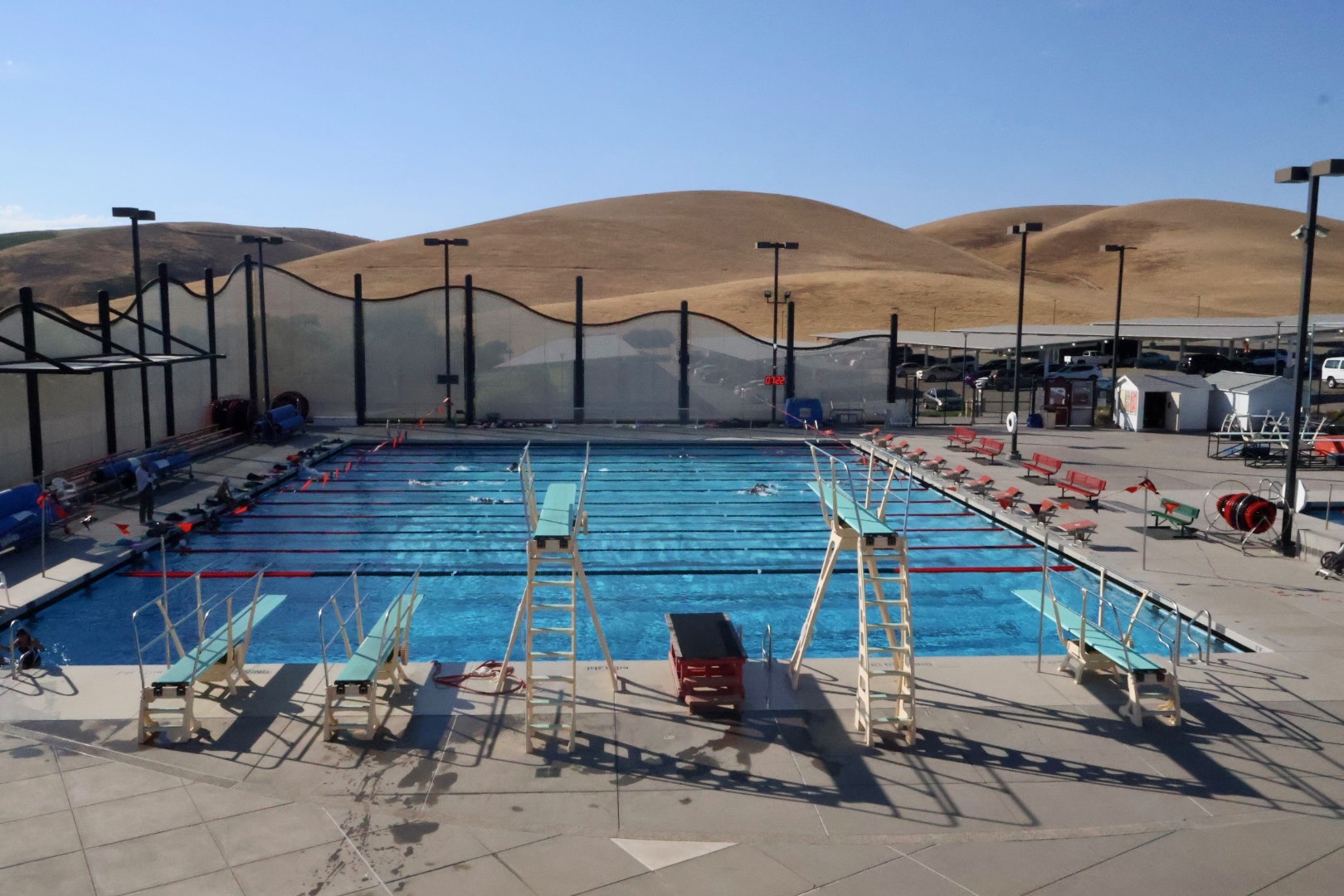 Las Positas College Aquatics Center pool deck with diving boards and the Livermore hills behind